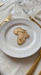 Africa silhouette resin place card with gold leaf held in hand showing size and transparency